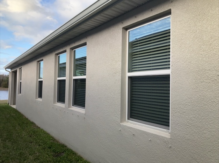 Impact-rated window and hurricane shutters documented during wind mitigation inspection